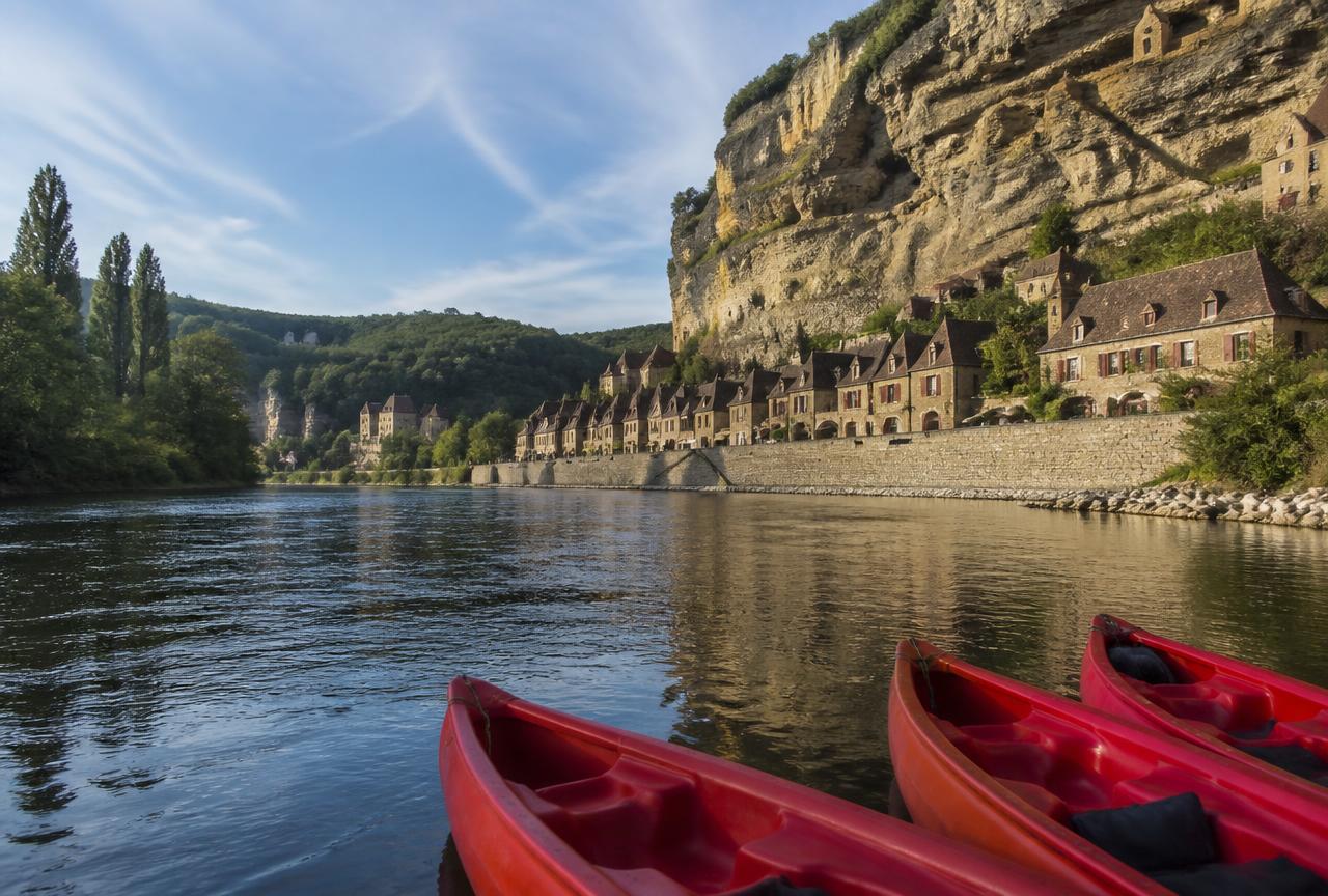 Canoes on the Dordogne below the cliff at La Roque-Gageac
