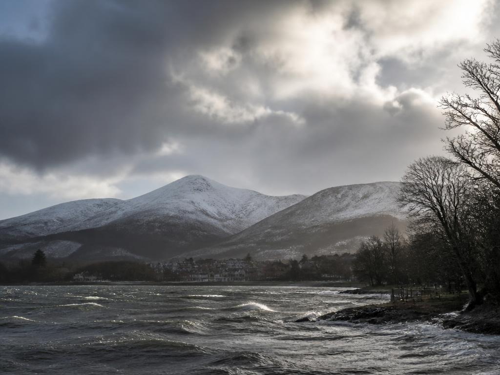 Winter storm light over the snow-dusted Mourne Mountains and Carlingford Lough