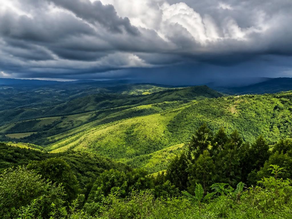 A summer thunderstorm building over the lush Valley of a Thousand Hills